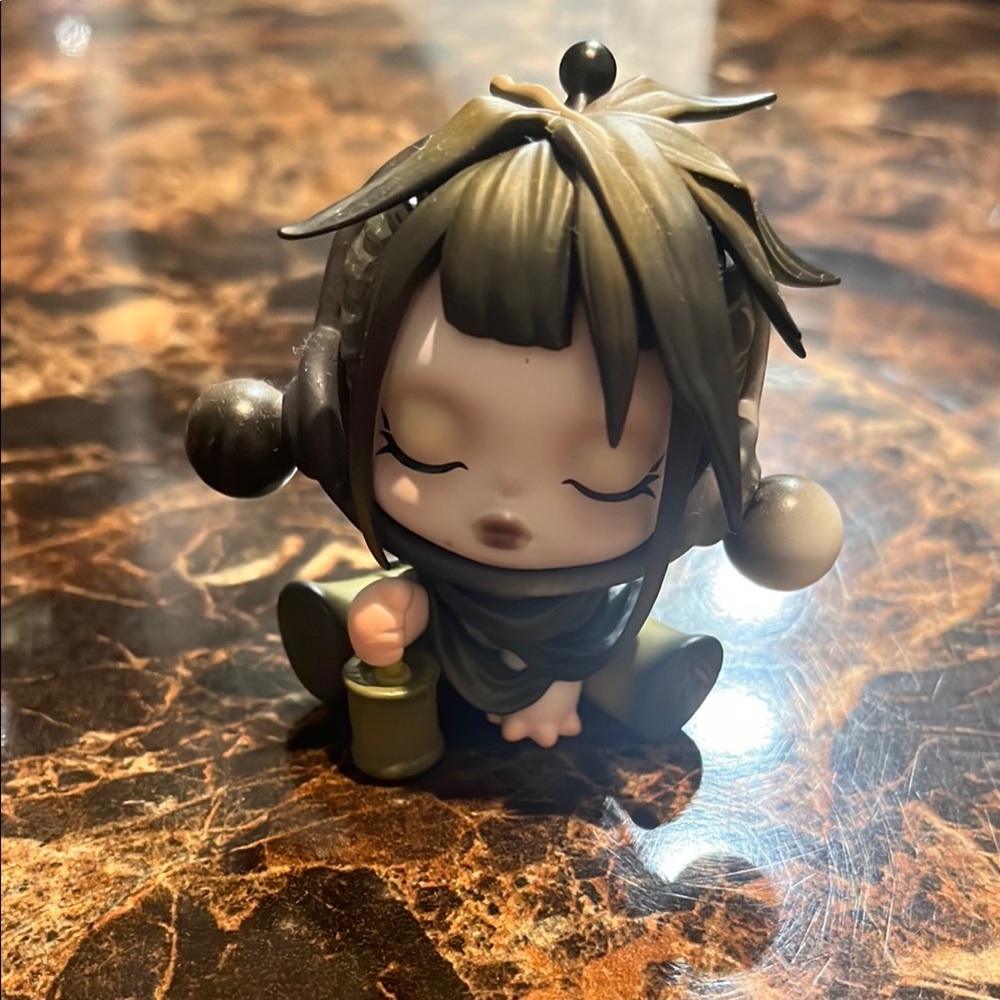Cute Action Figure with Black and Green Accents